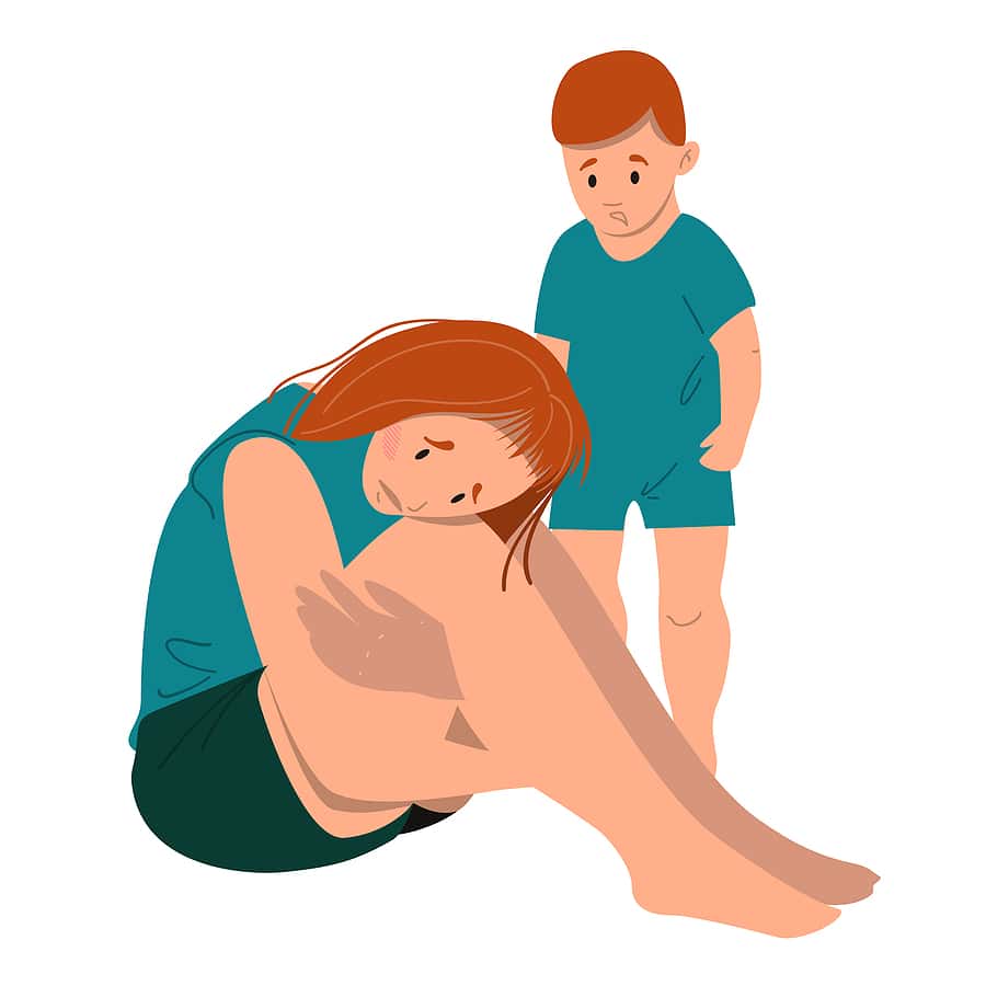 Sad mother sitting on the floor with her crying child