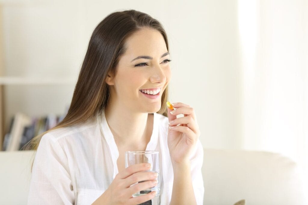 Women taking a vitamin