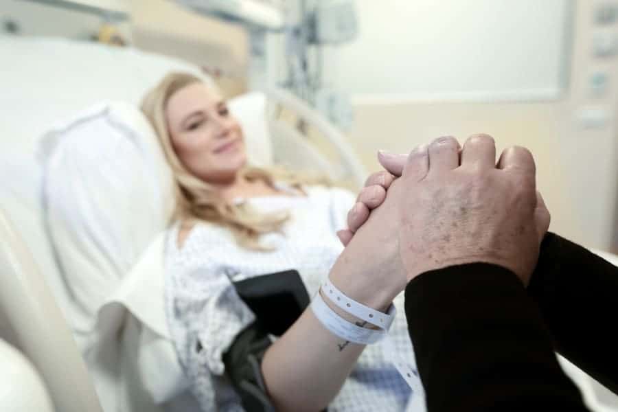 Woman in labor holding husband's hand