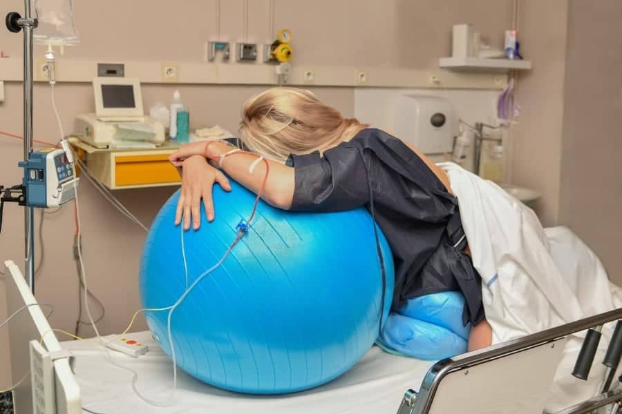 Woman holding a birthing ball in labor