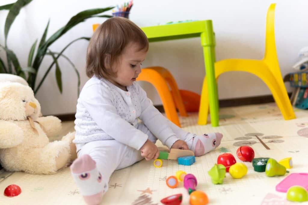 Toddler girl playing with toy food