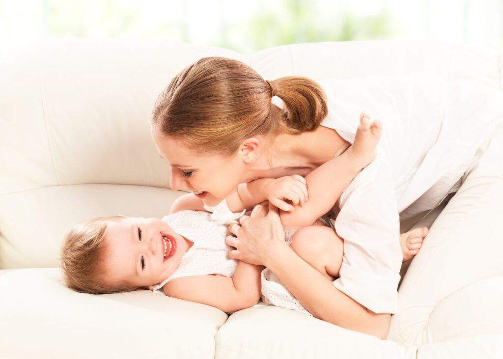 mom tickling baby girl