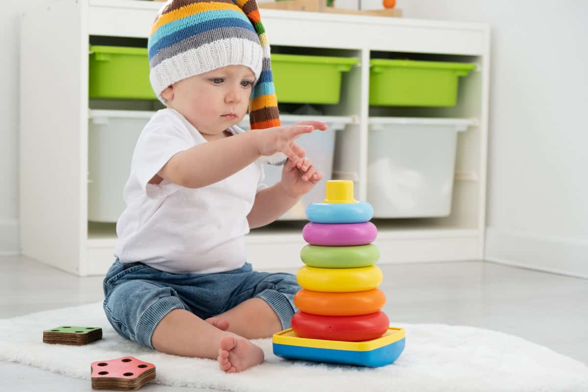 baby with stacking toys