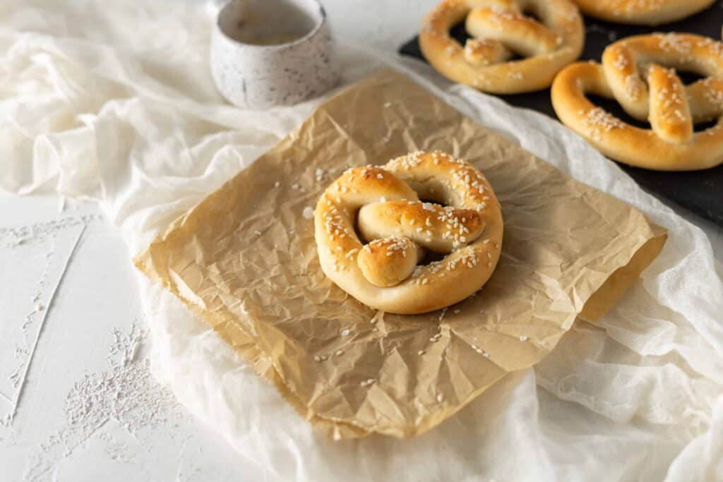 a soft pretzel on a parchment paper