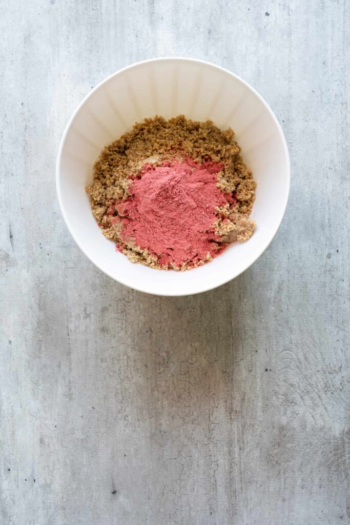 powder of crushed strawberries in a bowl along with other ingredients