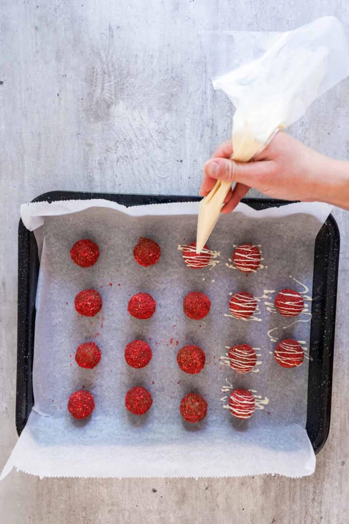 Drizzle the melted white chocolate over the bites