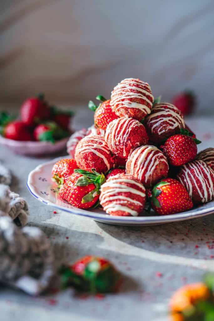 Strawberry Shortcake Energy Bites stacked in a plate