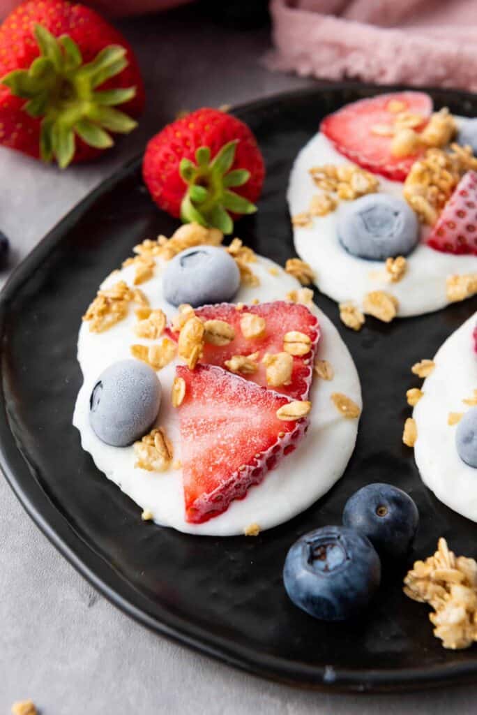 Bite-sized frozen vanilla yogurt clusters loaded with fresh fruit and crunchy granola for a nutritious indulgence.