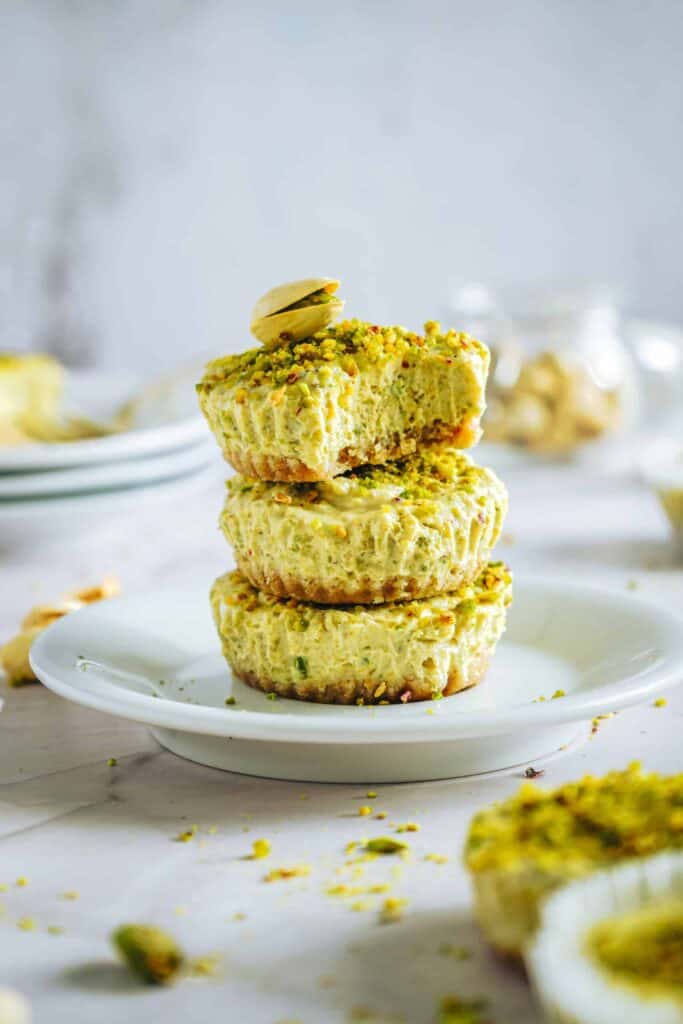 Mini Pistachio Greek Yogurt Cheesecakes with pistachio topping.
