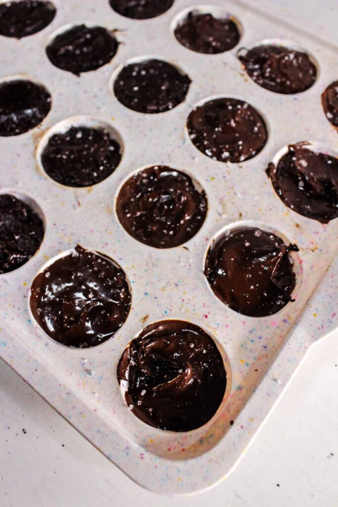 Brownie bites in a silicone muffin tray placed in the freezer to set