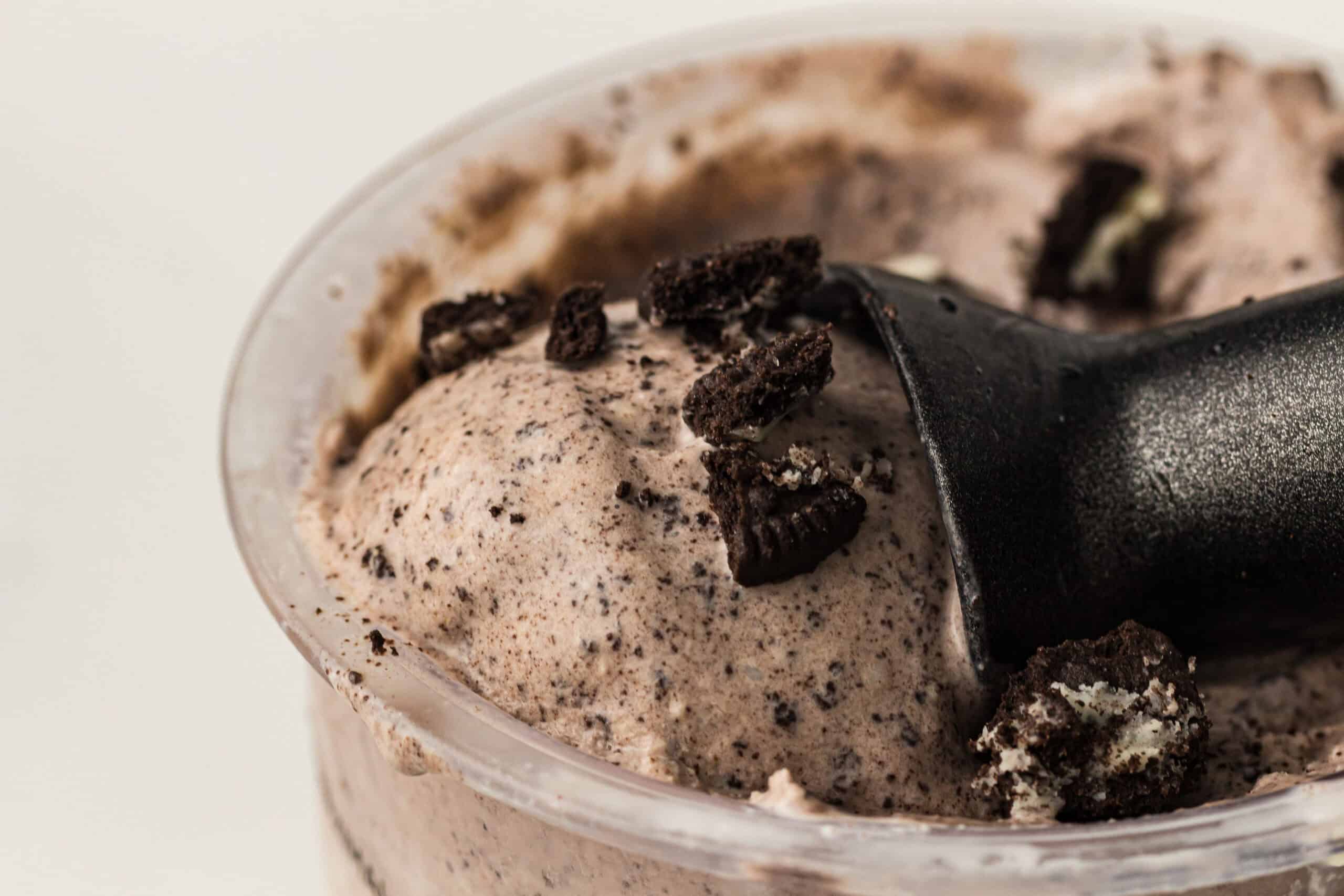 Using an ice cream scooper to scoop the ice cream.