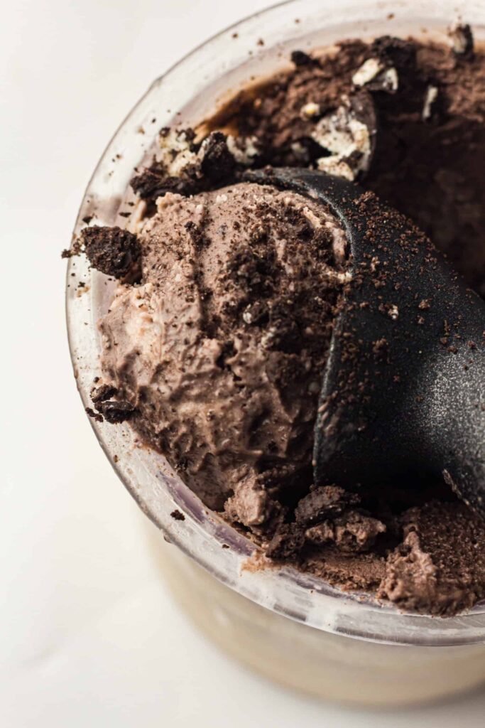 Delicious cookies and cream ice cream topped with rich chocolate syrup in a glass bowl. Perfect for.
